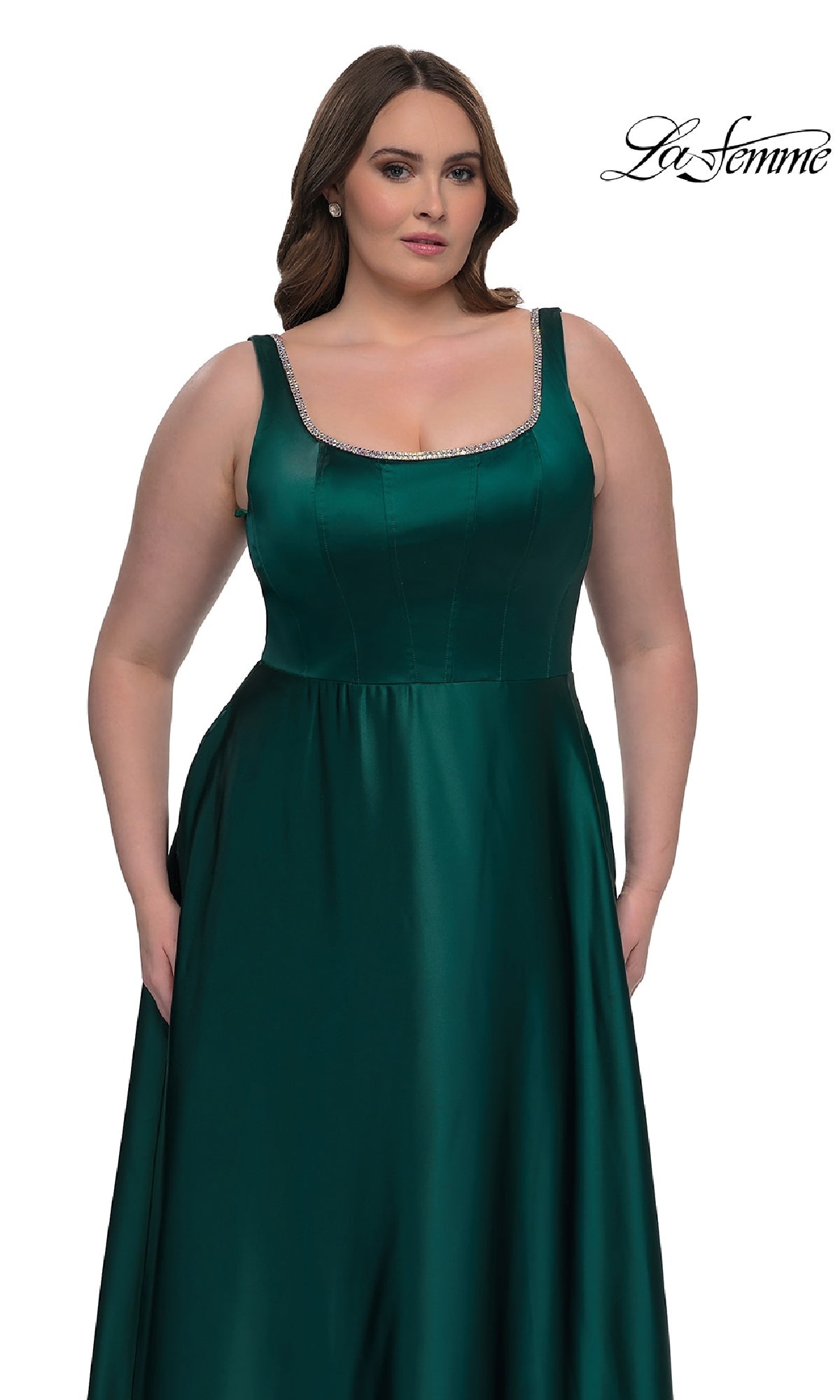 A woman in a sleeveless emerald green La Femme 33026 plus-size satin gown with a square neckline and beaded trim stands against a white background. The La Femme logo appears in the top right corner.